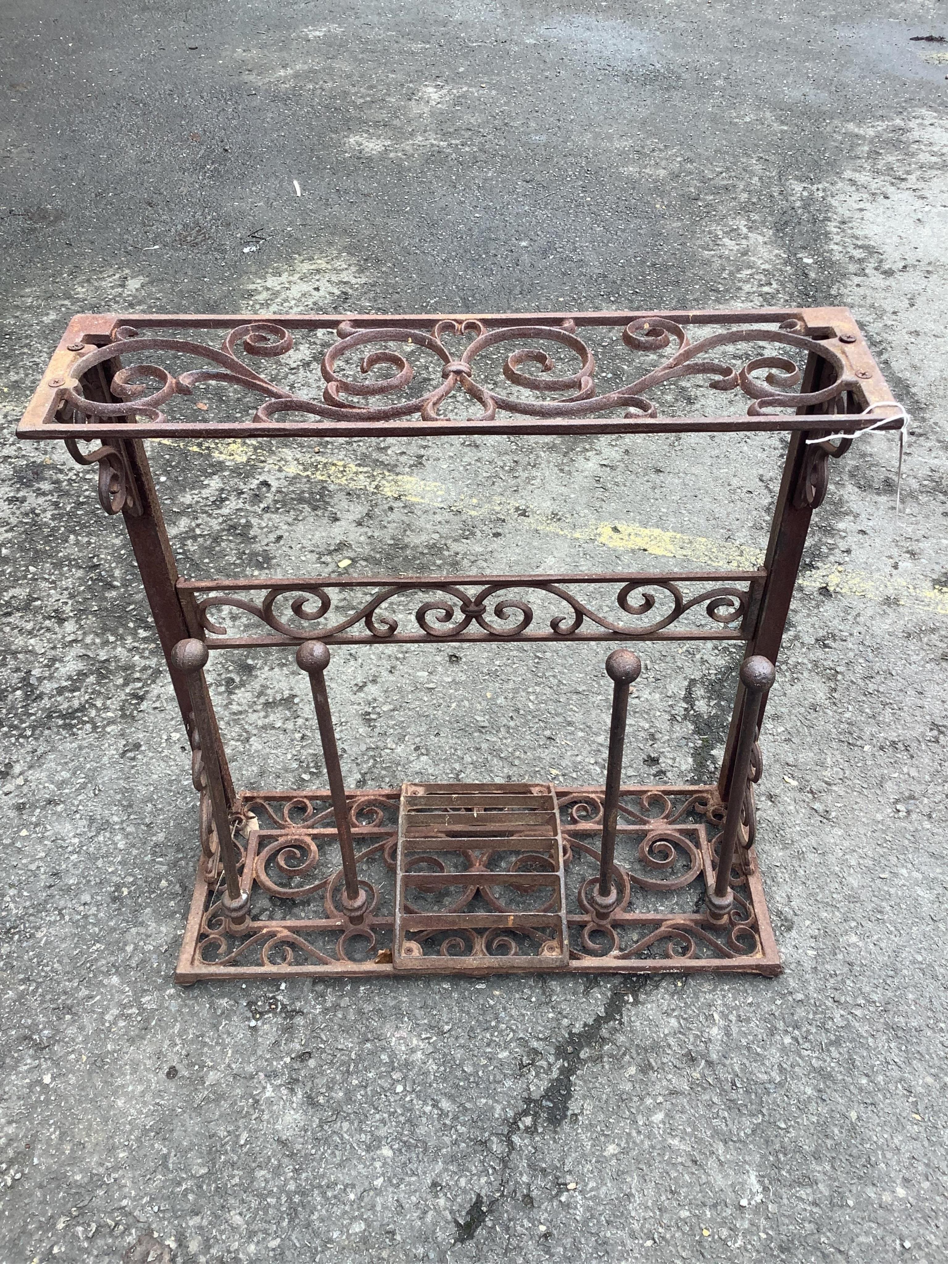 A cast metal boot stand, width 58cm, height 60cm. Condition - fair